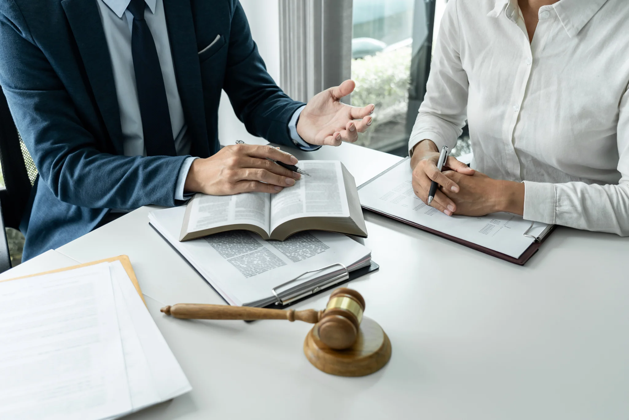 Lawyers discussing legal documents in office.