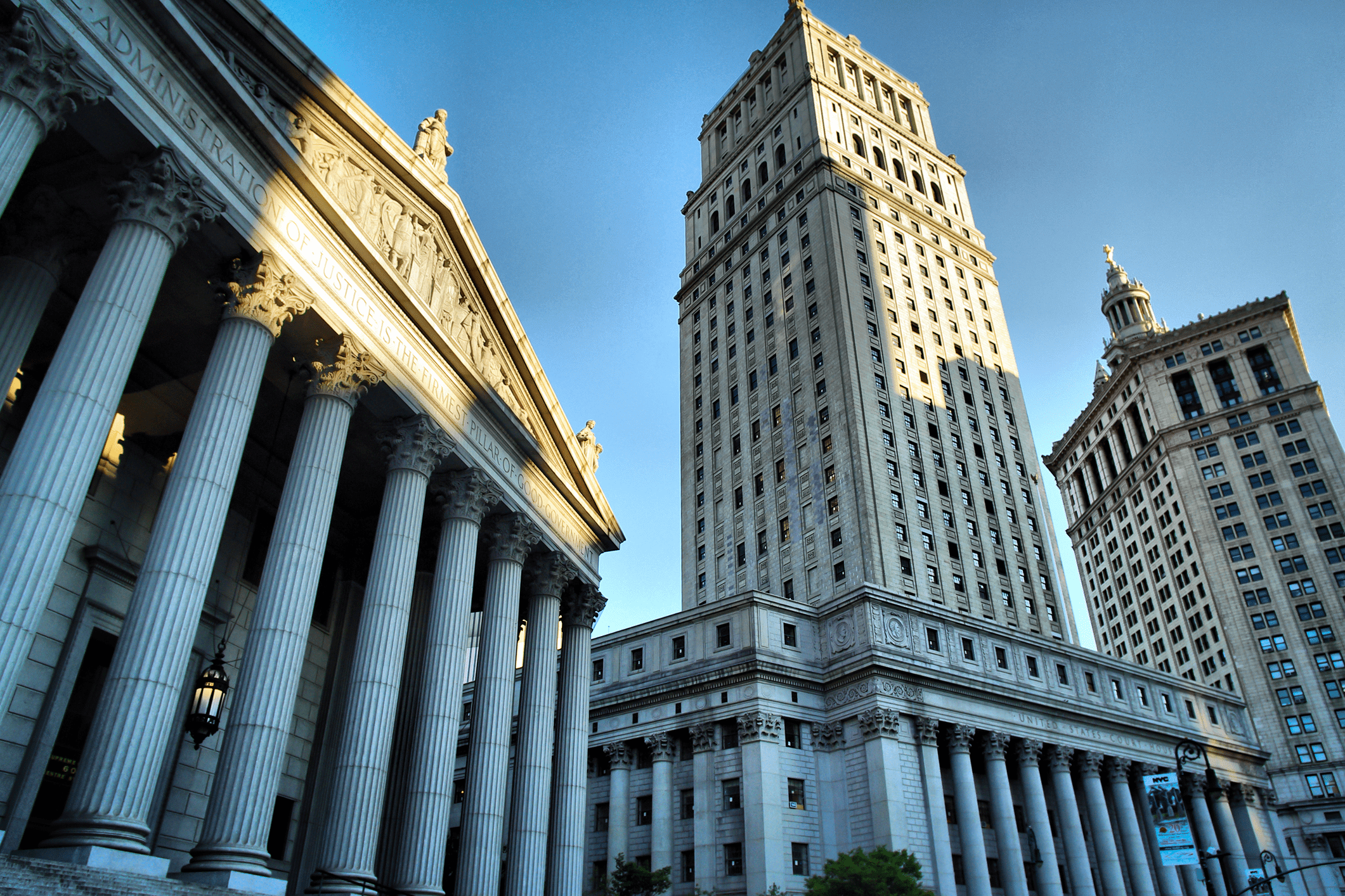 Historic buildings with columns under blue sky.