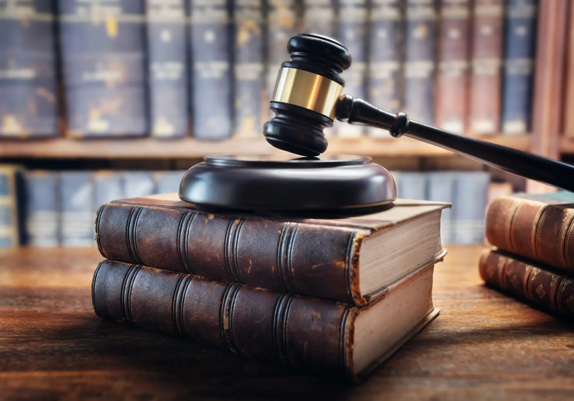 Gavel on stacked books in library.