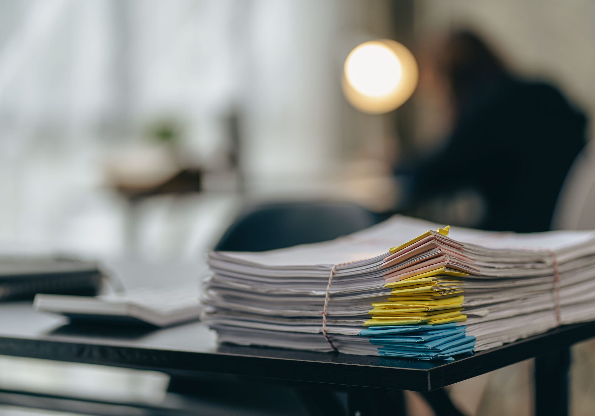 Stack of papers on a desk.